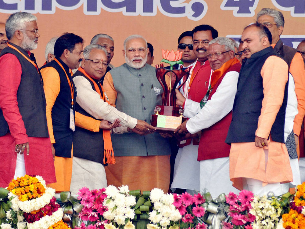 Prime Minister Narendra Modi being presented a memento by UP BJP President Keshav Prasad Maurya and other leaders at the BJP Vijay Shankhnad Rally in Meerut on Saturday ahead of the Assembly polls. PTI Photo