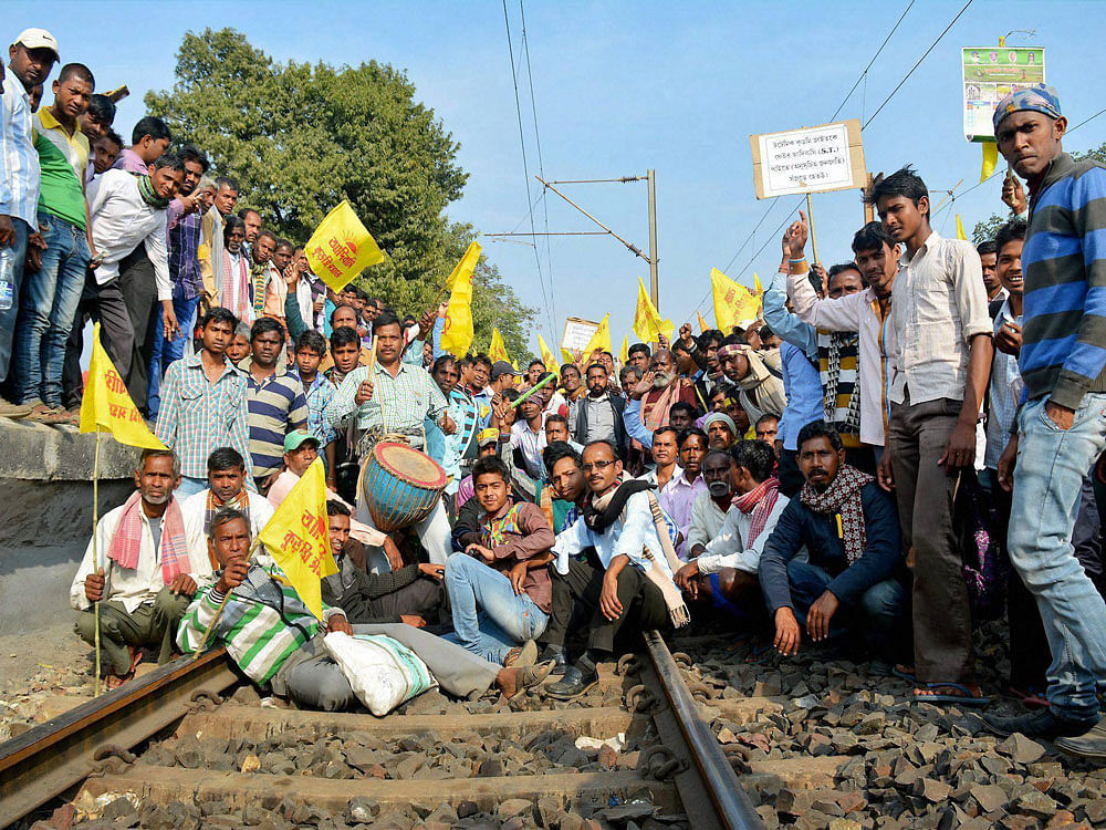 Kurami community block railway tracks during their agitation demanding ST status for them in Purulia in West Bengal on Monday. PTI Photo