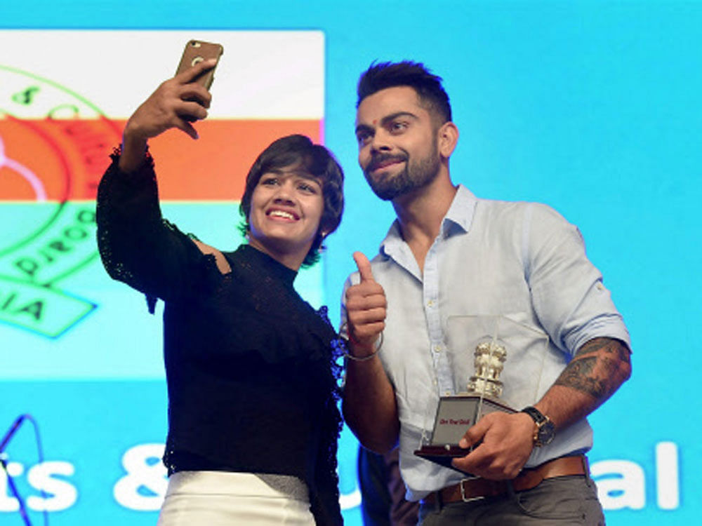  Team India captain, Virat Kohli and Wrestler, Babita Phogat during the concluding ceremony of the 49th All India Central Revenue Sports Meet in Mumbai on Friday. PTI Photo