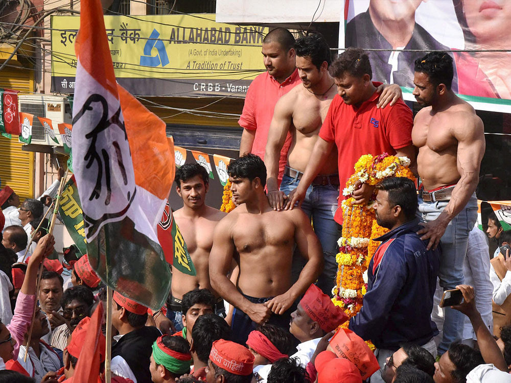  Body builders at Uttar Pradesh Chief Minister Akhilesh Yadav and Congress Vice-President Rahul Gandhi's road show in Varanasi on Saturday. PTI Photo