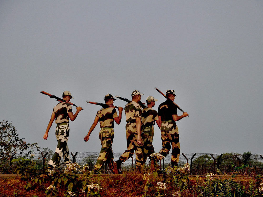 BSF jawans patrolling the Indo-Bangladesh International Border in Agartala on Monday. PTI Photo