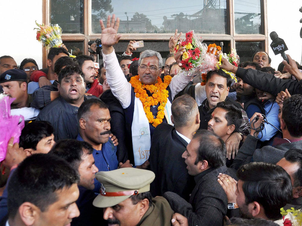 BJP leader Trivendra Singh Rawat being greeted by supporters after he was elected as the party's legislative party leader in Dehradun on Friday. PTI Photo