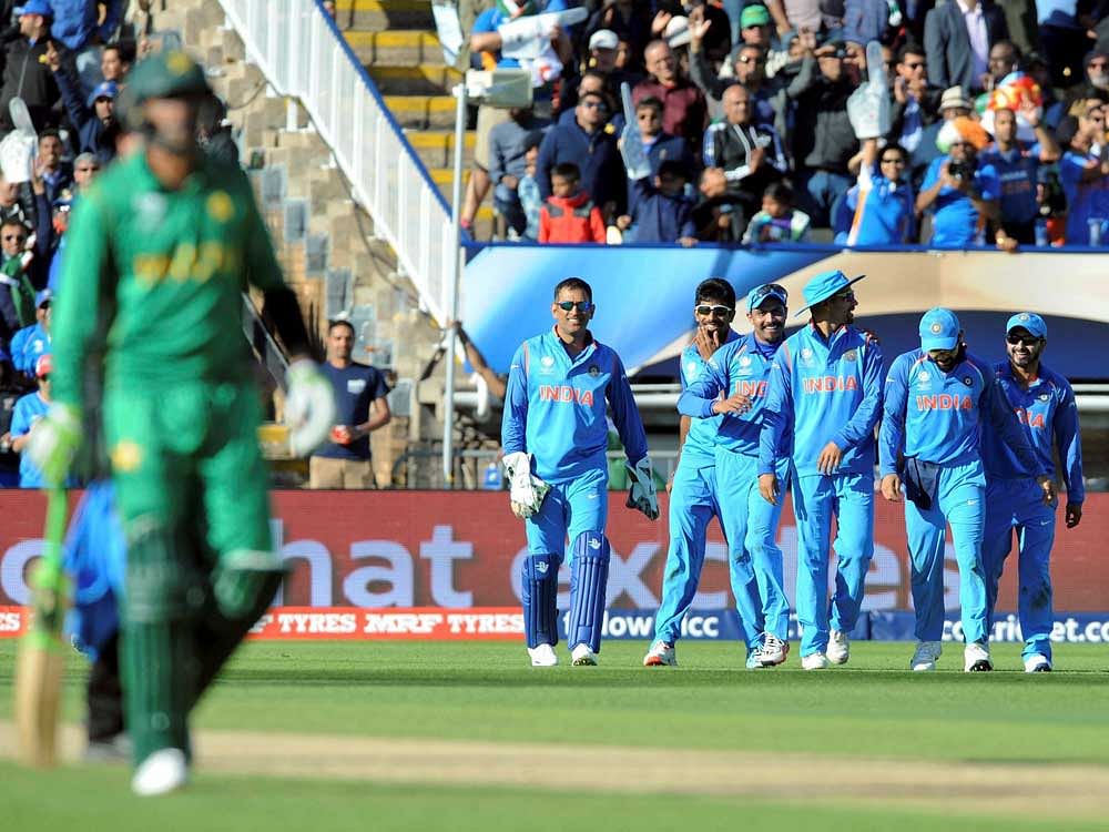 Indian cricketers watch Pakistan's Shoaib Malik leave the field after he was dismissed by Ravindra Jadeja during the ICC Champions Trophy match between India and Pakistan at Edgbaston in Birmingham, England. AP/PTI Photo