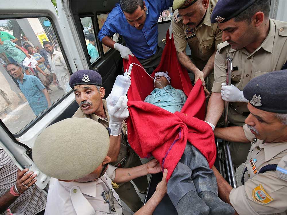 A man who was injured after a bus he was travelling in skidded off a mountain road and fell into a gorge in Jammu and Kashmir's Ramban district, is rushed to a hospital for treatment in Jammu July 16, 2017.