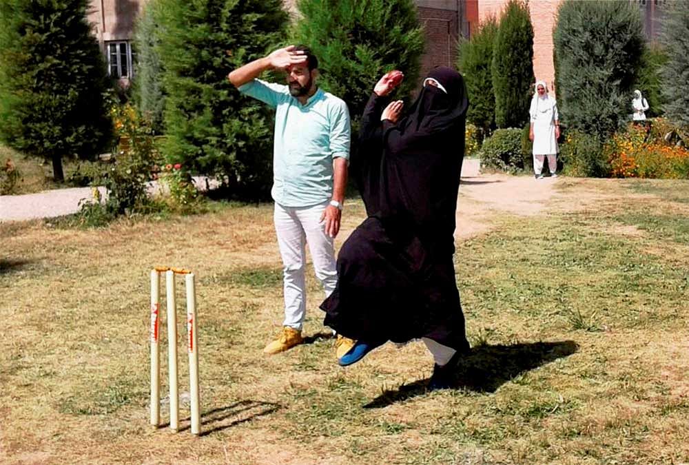 Cricket in burqa. A woman cricketer in Baramulla defying social restrictions in her passion for the sport. PTI