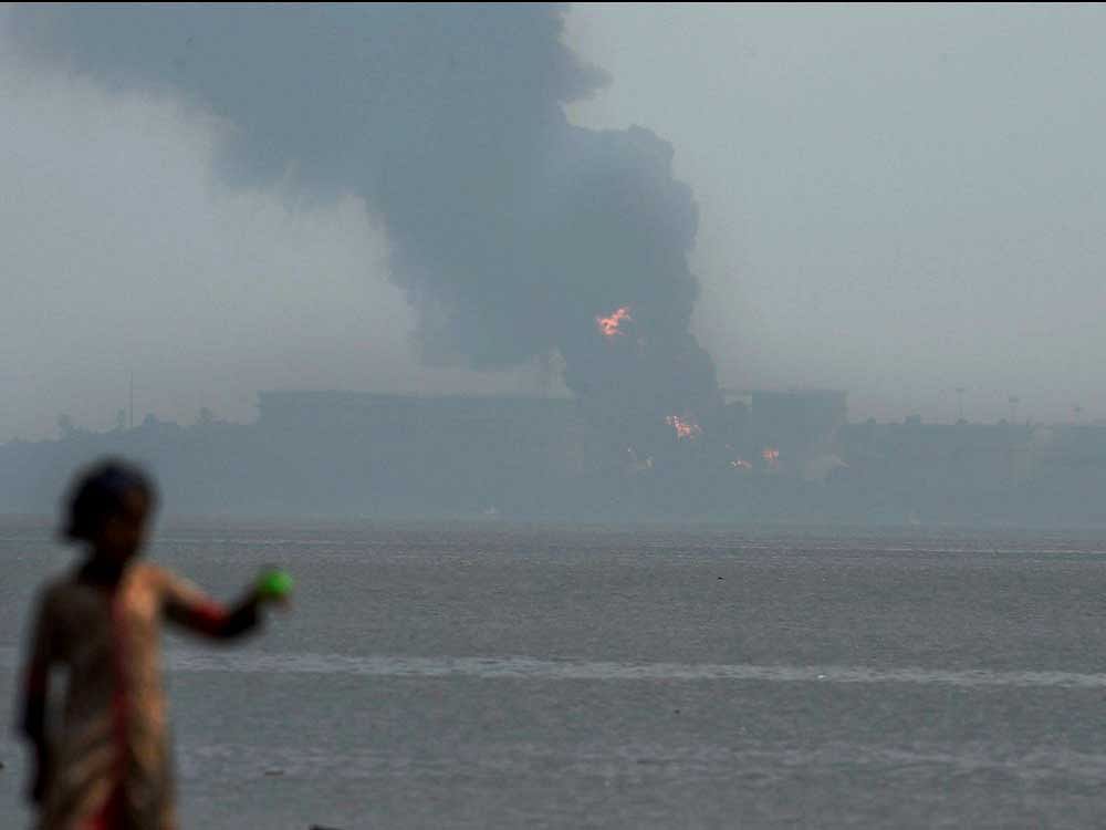 Smoke billowing out of an oil tanker on Butcher Island off the east coast of Mumbai on the second day of the fire on Sunday.