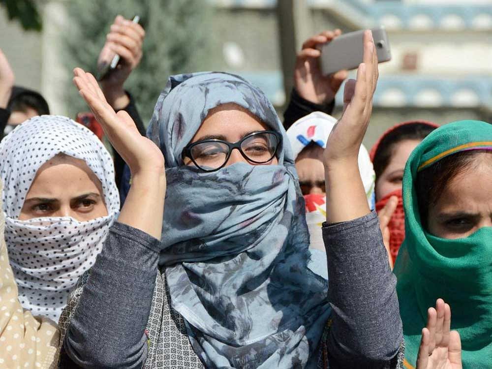 Students shout slogans during a protest rally against the fresh incidents of braid chopping in the Valley, at Kashmir University in Srinagar on Thursday.