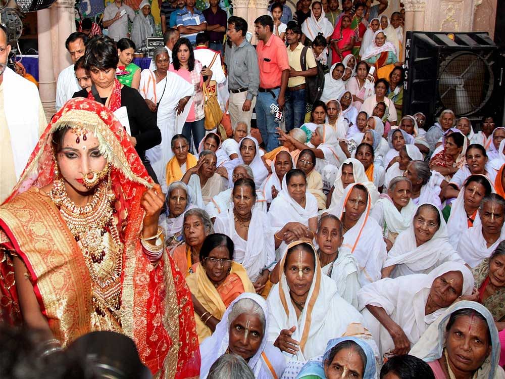 Widows attending the marriage ceremony of a young widow at Gopinath Temple in Vrindavan near Mathura on Monday. PTI Photo