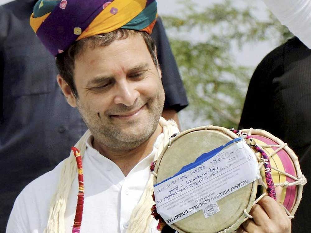  Congress vice president Rahul Gandhi plays a musical instrument at an interaction program at Harij in Patan district on Monday.