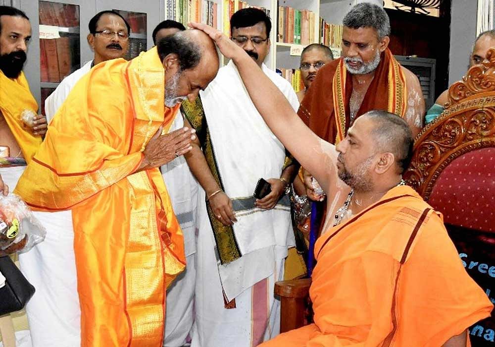 Rajinikanth seeks blessings of head priest of the Sri Raghavendra Temple at Mantralayam in Kurnool district, Andhra Pradesh on Tuesday during his vist. The actor is a devotee of Sri Raghavendra, a 17th century saint. The actor had portrayed the saint...