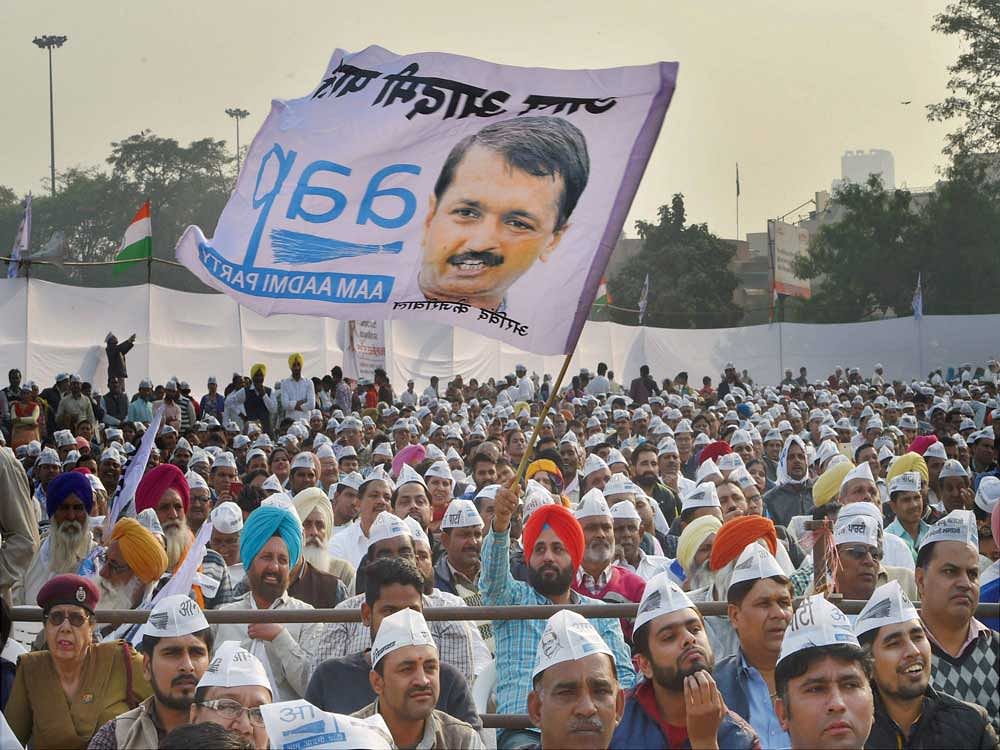 AAP volunteers during a convention to mark the party's 5th Foundation Day at Ramlila Maidan in New Delhi on Sunday. PTI Photo