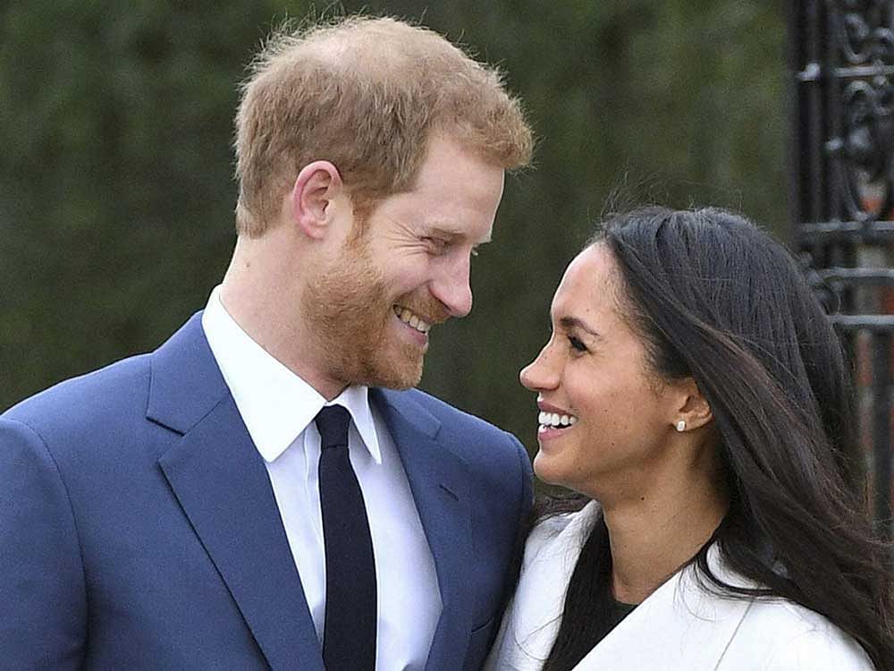  Britain's Prince Harry and Meghan Markle smile as they pose for the media in the grounds of Kensington Palace in London. AP/PTI