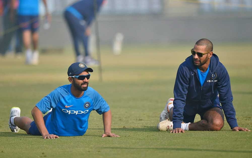 India Cricket team members Shikhar Dhawan and A Rahane during a practice session in New Delhi on Friday. PTI