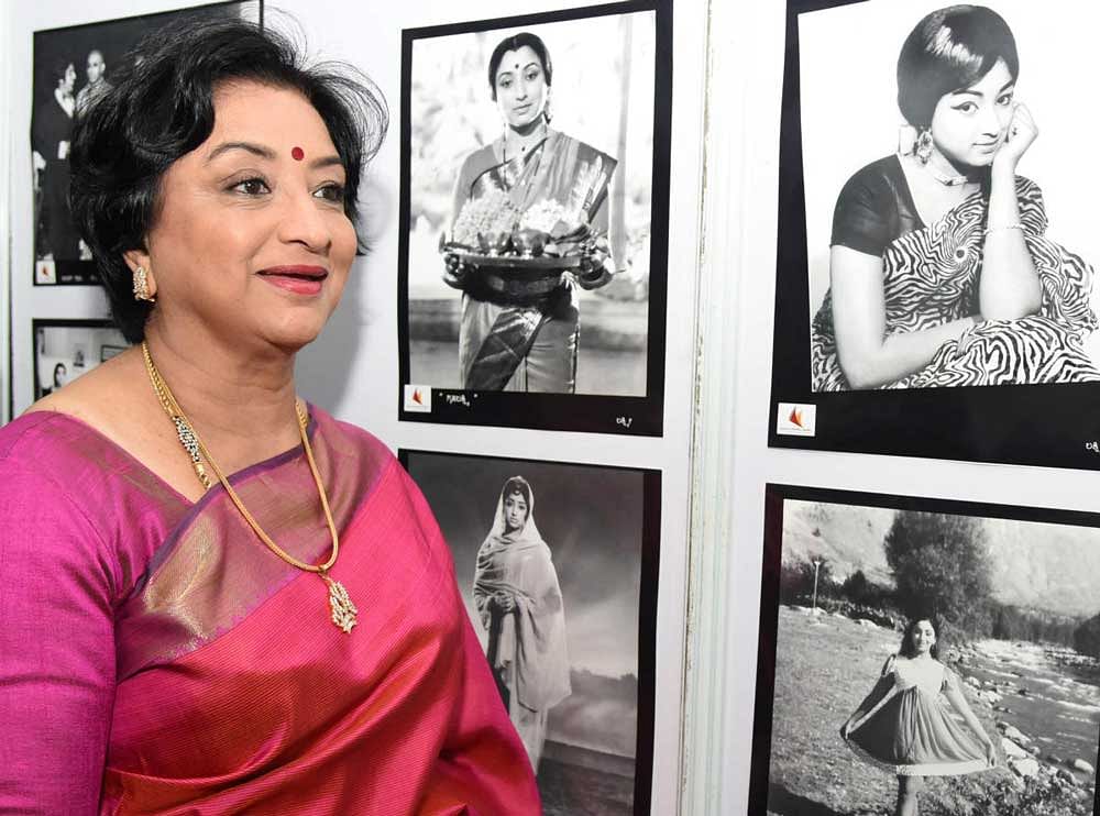 Film actress Lakshmi takes look on her photo exhibition at Gandhi Bhavan organised by Karnataka Chalanachitra Academi in Bengaluru on Sunday. DH Photo by B K Janardhan