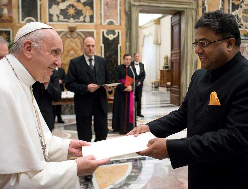 Pope Francis receives a credential letter from Sibi George, new Ambassador of India to the Holy See, during an audience at the Vatican December 14, 2017. Osservatore Romano/Handout via Reuters