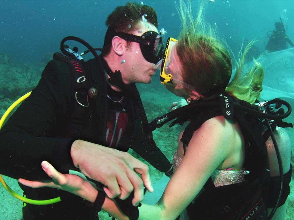 In this photo provided by the Florida Keys News Bureau, British Army Sergeant Thomas Mould, left, and Sandra Hyde, right, kiss after signing off on wedding vows during an underwater ceremony off Key Largo, Fla., in the Florida Keys National Marine Sa...
