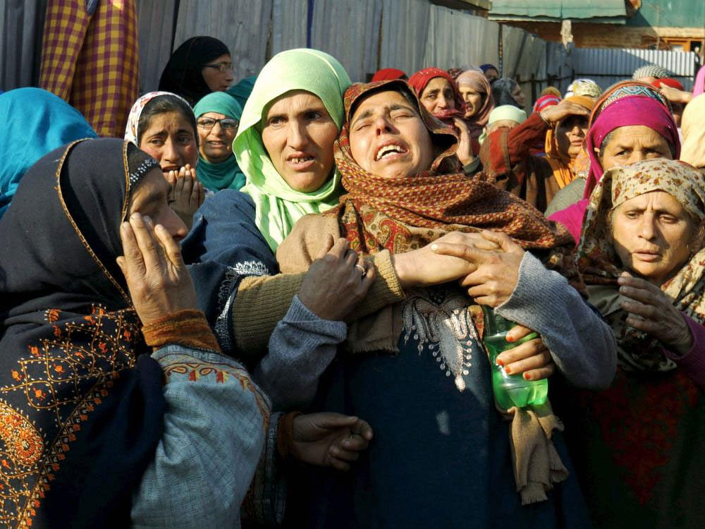Wife of Constable Ghulam Nabi cries during his funeral procession, at Rohama in Rafiaabad on Saturday. Police Constable Ghulam Nabi was killed along with three other police personnel in an IED blast at Sopore town of north Kashmir's Baramulla distric...
