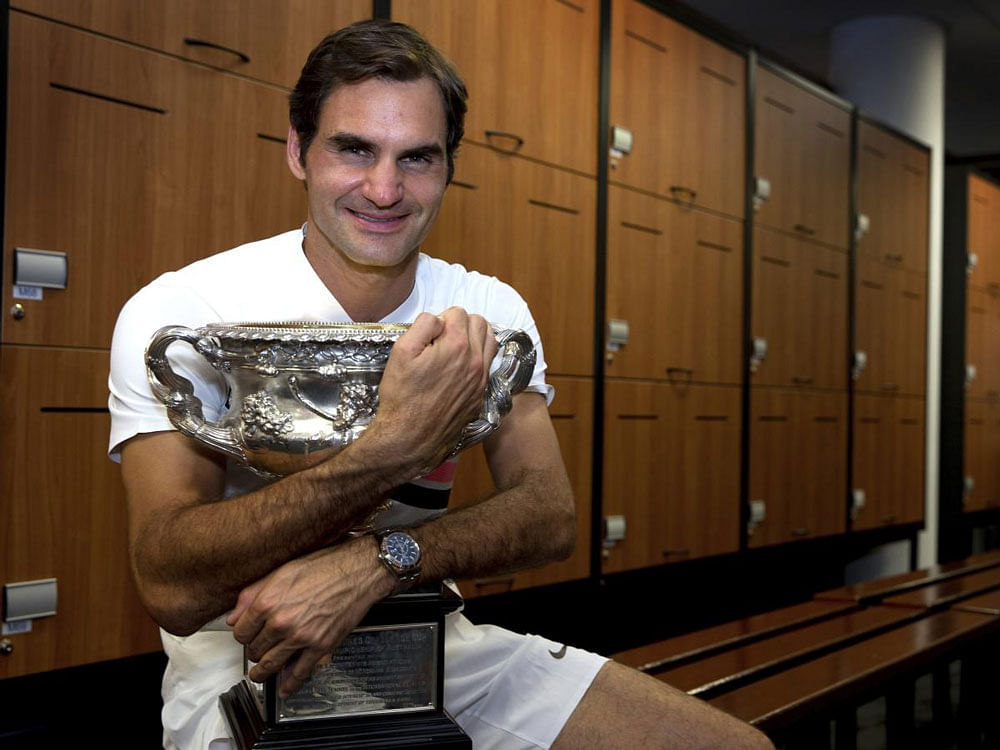 Switzerland's Roger Federer poses with his trophy, the Norman Brookes Challenge Cup after winning the men's singles final against Croatia's Marin Cilic at the Australian Open tennis championships in Melbourne, Australia, Monday, Jan. 29, 2018. AP/PTI...