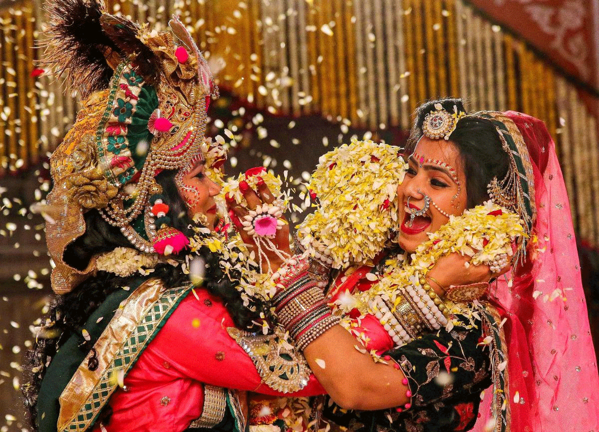 Artists dressed as Lord Krishna and Radha play with flowers during 'Fag Mahotsav' celebration at historical Govind Dev Ji temple, in Jaipur on Monday. PTI Photo
