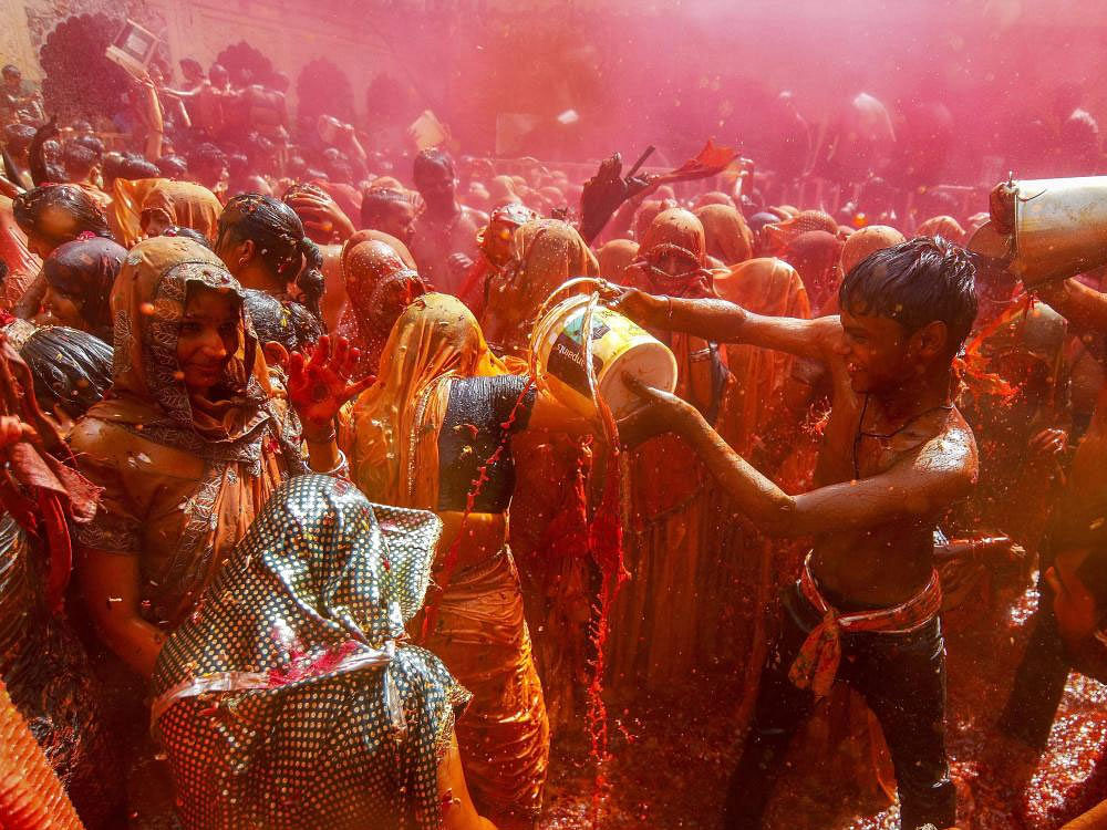 People play Huranga Holi at Dauji Temple, during Holi celebrations near Mathura on Sarurday. 