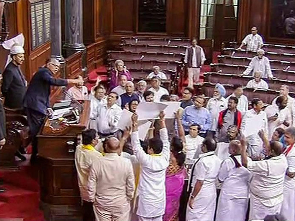 Opposition members protest in the well of the Rajya Sabha in New Delhi on Tuesday. 