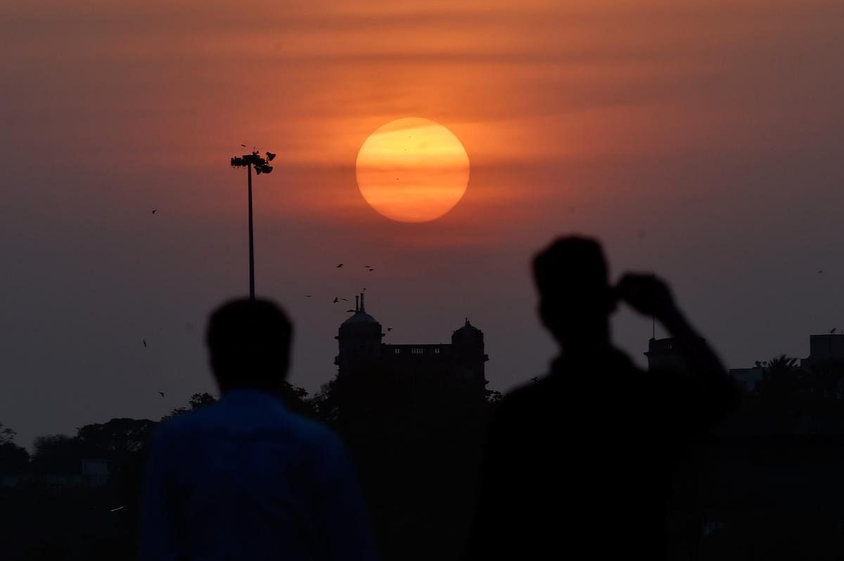 A view of the sunset seen from the back water area of Marina beach in Chennai on Sunday. PTI Photo
