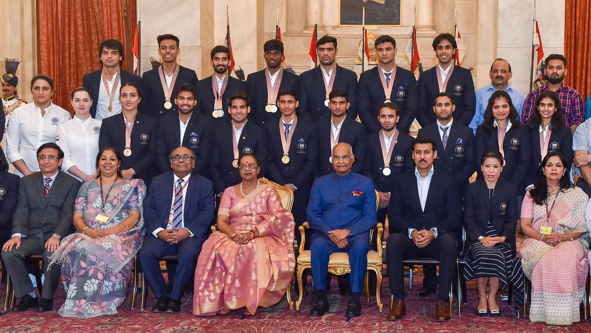 President Ram Nath Kovind and his wife Savita Kovind pose for a group photo with the medal winners of the Commonwealth Games 2018, at Rashtrapati Bhawan in New Delhi on Monday. PTI Photo