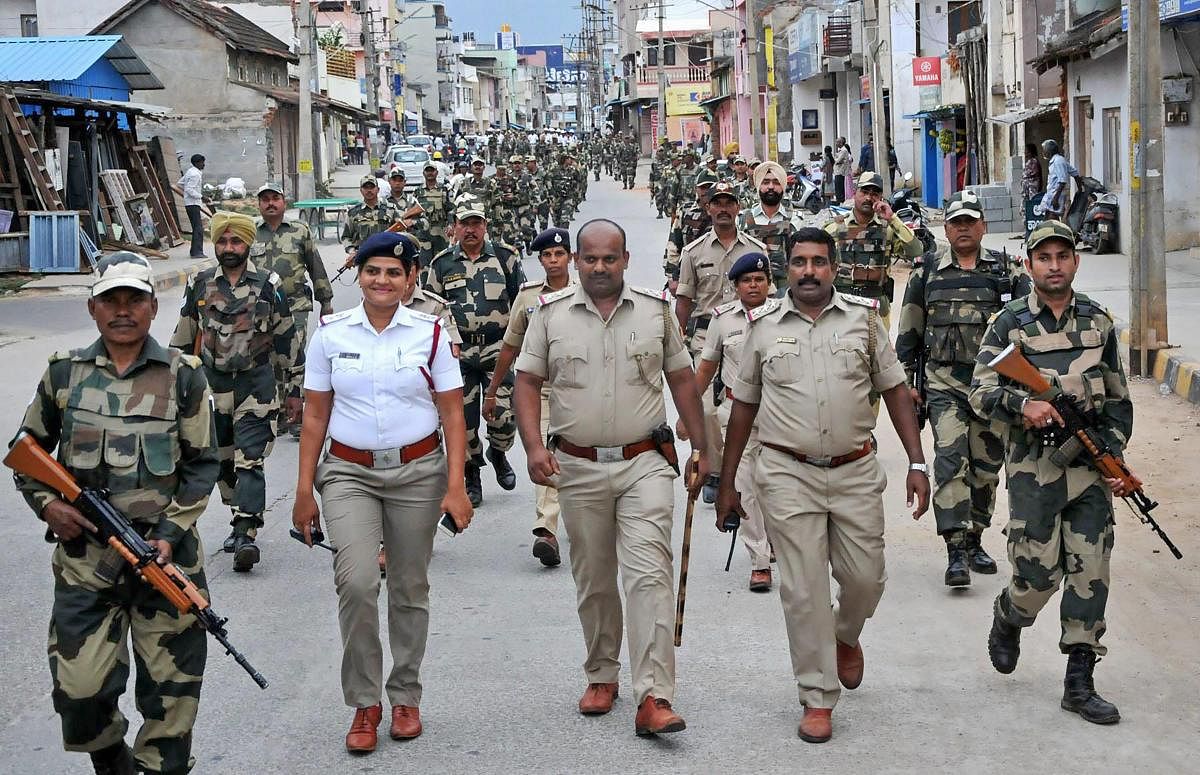 Security personnel march ahead of Karnataka assembley elections at Chikmagalur in Karnataka on Sunday. PTI