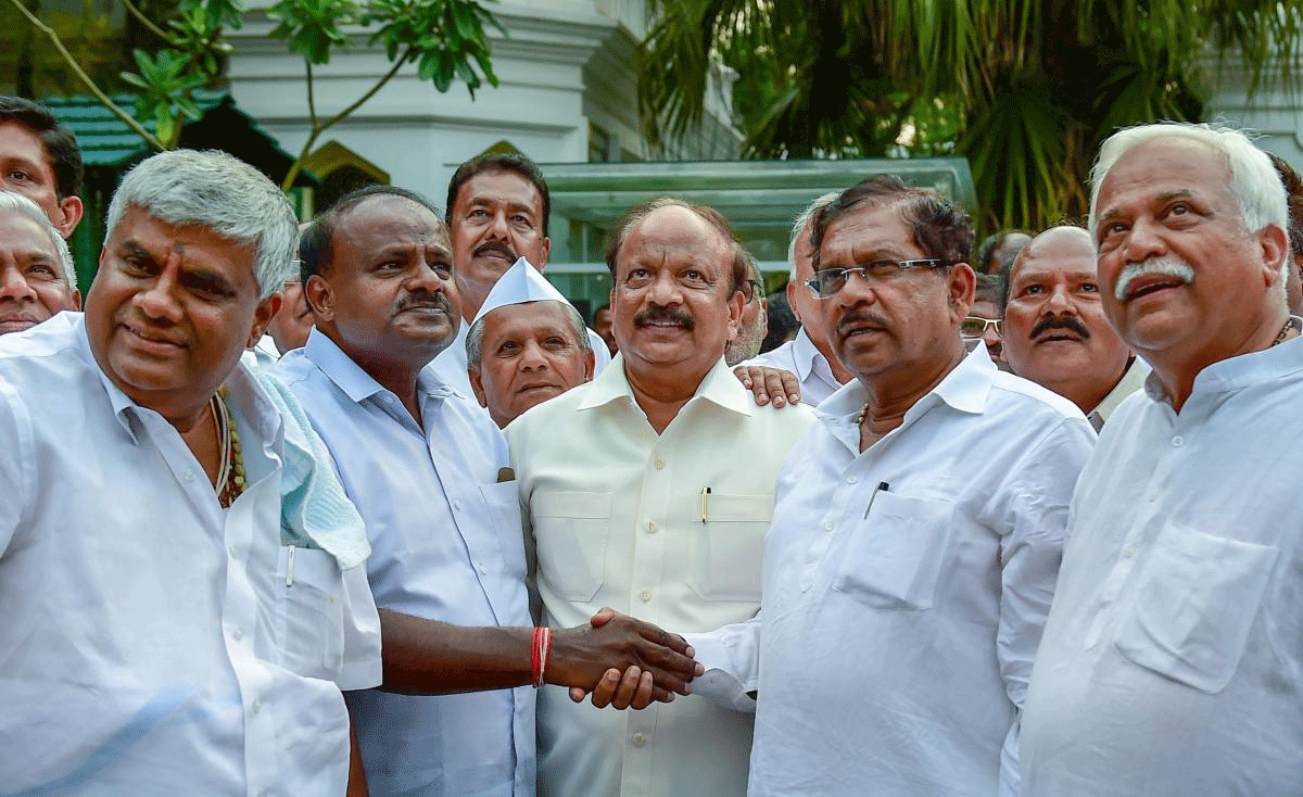 JD(S) President HD Kumaraswamy greets KPCC President G Parameshwara after meeting with Governor to stake claim to form the coalition government in the state, outside the Rajbhavan in Bengaluru on Wednesday. Congress extended the support to JD(S) to form the new Government in Karnataka. PTI Photo