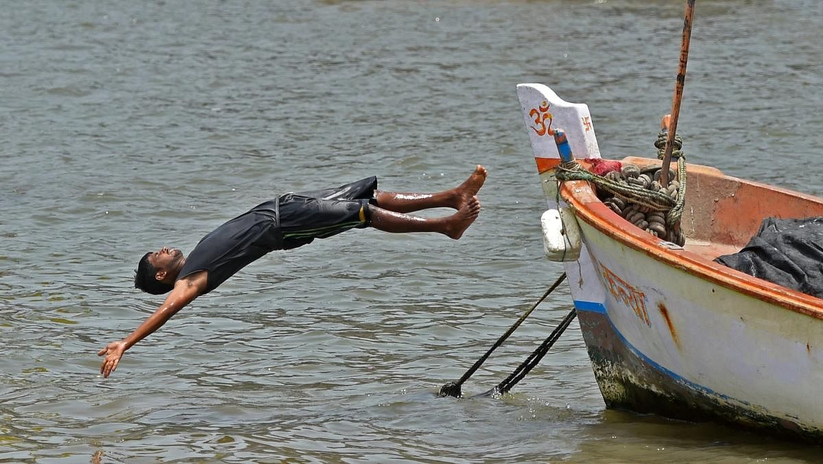 A boy dives into the Arabian Sea on a hot, summer day as day temperature soar, in Mumbai, on Thursday. PTI