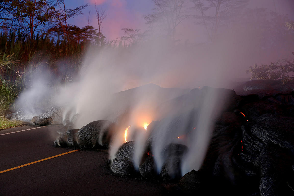 Volcanic gases rise from the Kilauea lava flow that crossed Pohoiki Road near Highway 132, near Pahoa, Hawaii, U.S., May 28, 2018. REUTERS/Marco Garcia