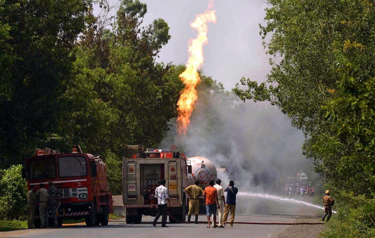 Firefighters douse the flames shooting up from an oil tanker which collided with a truck while carrying LPG, at Raipur in Birbhum district of West Bengal. PTI Photo