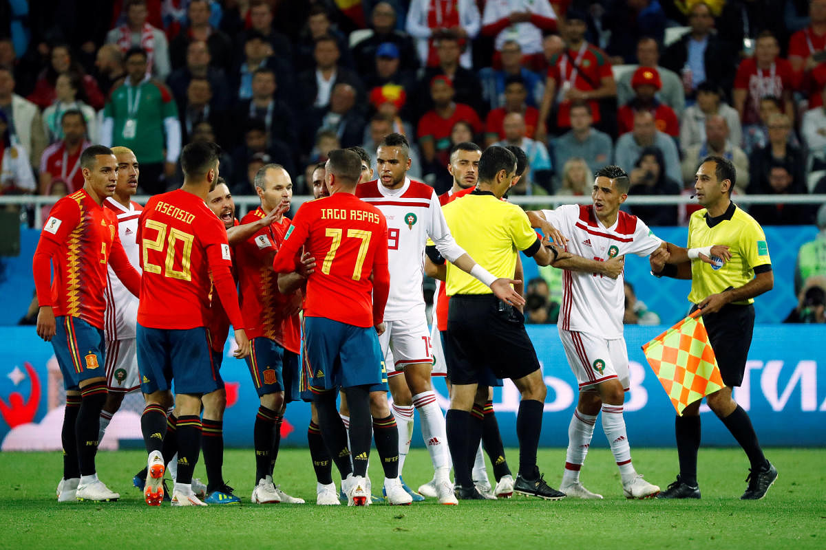  World Cup - Group B - Spain vs Morocco - Kaliningrad Stadium, Kaliningrad, Russia - June 25, 2018 Referee Ravshan Irmatov tries to separate players as Spain and Morocco clash. Reuters