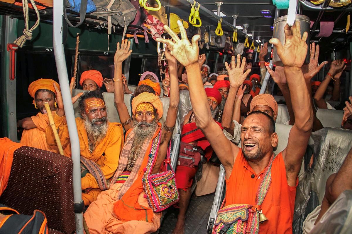 Sadhus shout religious slogans in a bus, as the first batch of pilgrims leaves for Amarnath Yatra, in Jammu on Wednesday, June 27, 2018. PTI