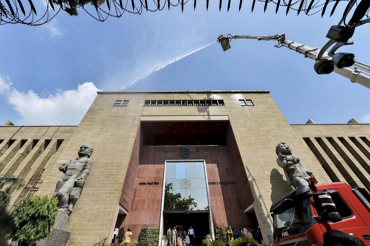 Firemen pour water through a sky lift during a mock drill at Reserve Bank of India (RBI) building in New Delhi, on Thursday, June 28, 2018. PTI