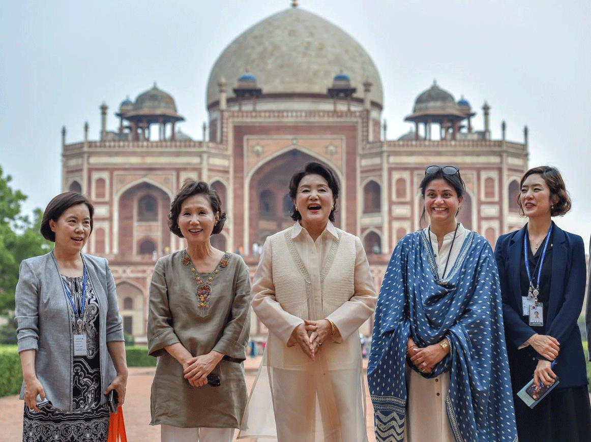 South Korean First Lady Kim Jung-sook (C) poses for photographs during her visit at Humayun's Tomb, in New Delhi on Monday, July 9, 2018. PTI Photo