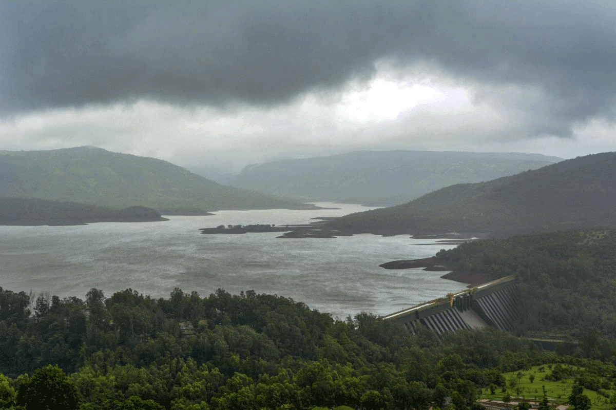 Dark Monsoon clouds are seen hovering over Koyna Dam, in Satara on Wednesday, July 11, 2018. The live water storage capacity of the dam has reached over 50% of its total capacity following heavy rainfall in the area. (PTI Photo)