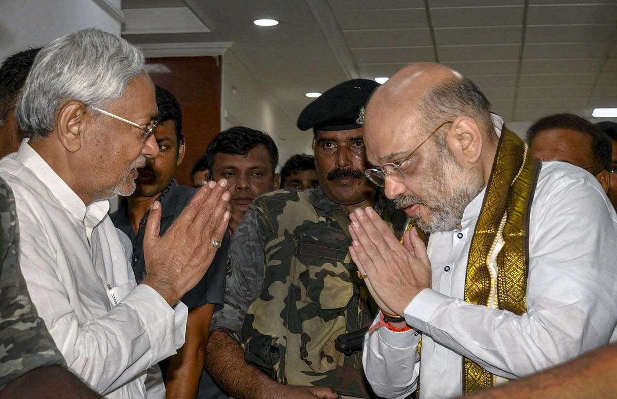 Bihar Chief Minister Nitish Kumar and Bharatiya Janata Party (BJP) President Amit Shah exchange greetings before a breakfast meeting at the state guest house, in Patna on Thursday, July 12, 2018. (PTI Photo) 