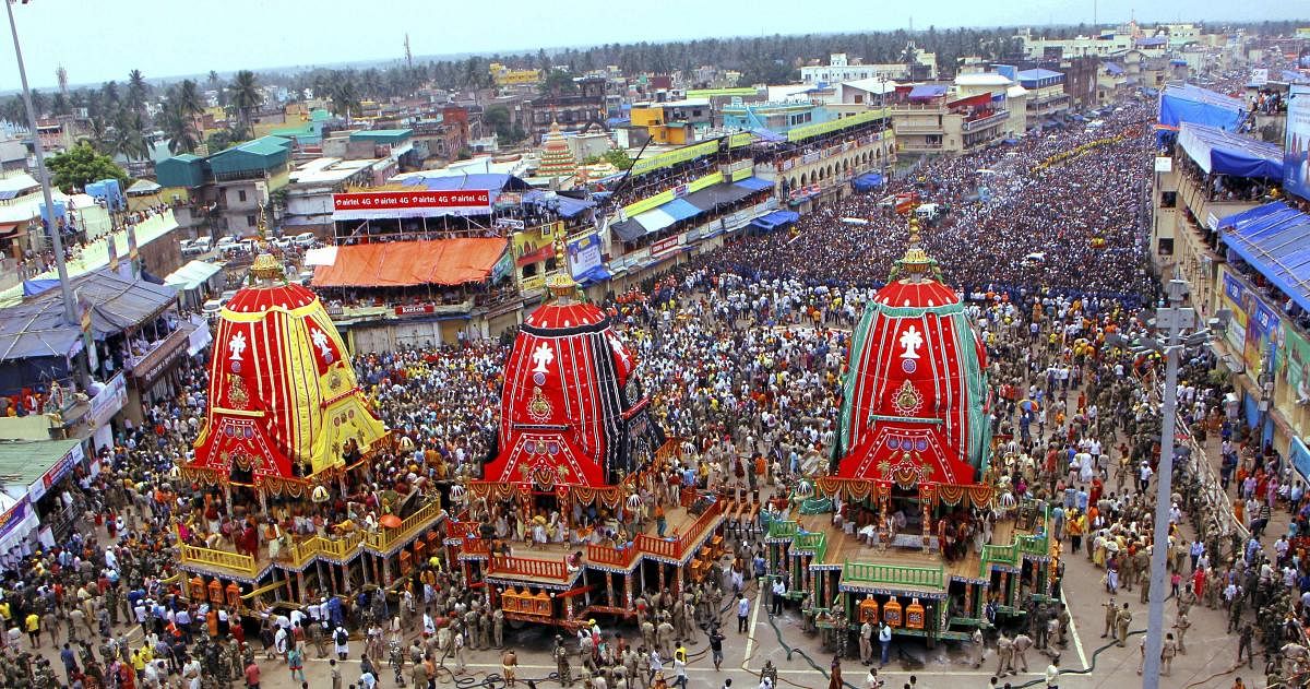 Devotees pull the chariots during the 141st Rath Yatra, in Puri on Saturday, July 14, 2018. The yatra is taken out every year on Ashadhi Bij, the second day of Ashad month, as per the Hindu calender. Besides the three chariots of Lord Jagannath, his brother Balram and sister Subhadra, the yatra procession comprises of 18 decorated elephants, 101 trucks with tableaux, members of 30 religious groups and 18 singing troupes. (PTI Photo)