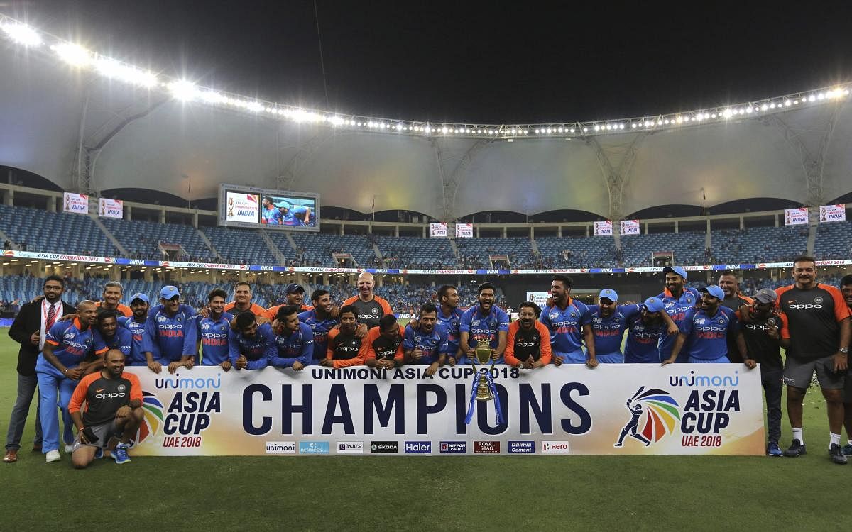 Indian players and team support staff celebrate with the trophy after winning the Asia Cup final cricket match against Bangladesh, in Dubai. (AP/PTI Photo)