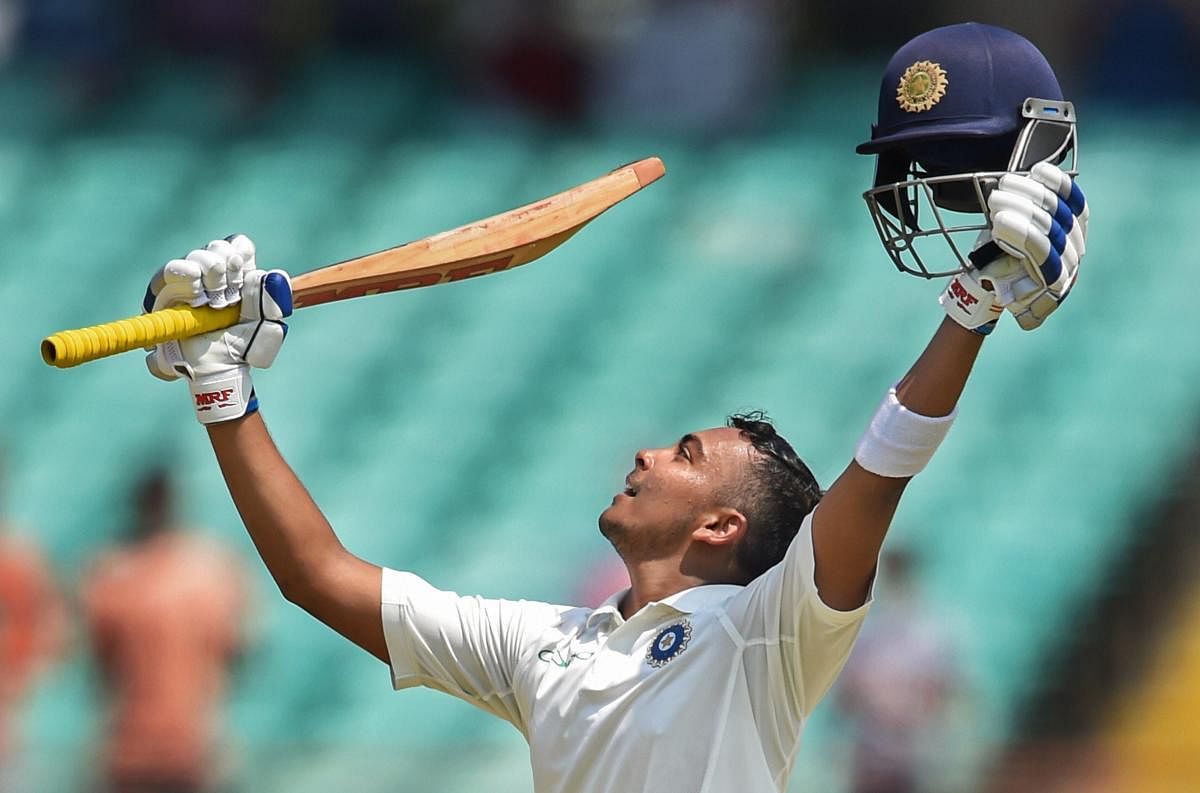 Prithvi Shaw celebrates his century on day one of the 1st test cricket match against West Indies, in Rajkot. Shaw becomes the youngest Indian cricketer to score 100 runs on on Test debut. (PTI Photo)