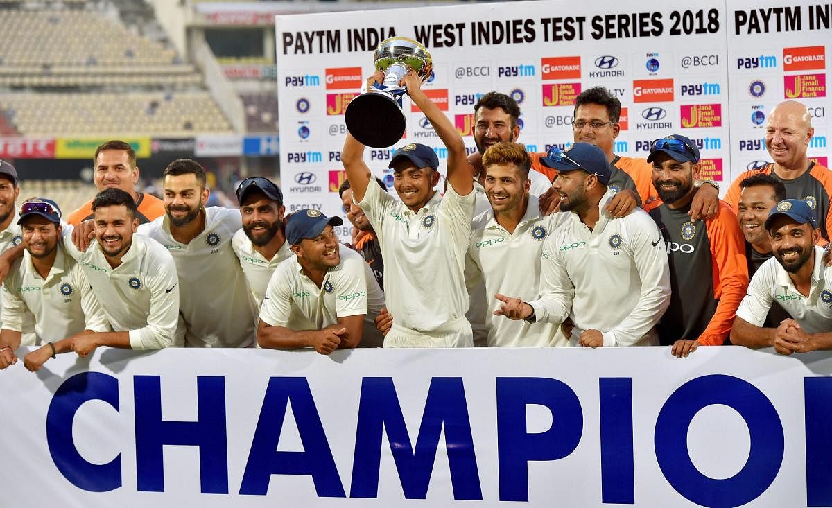 Indian cricket team players poses with winning trophy after beating West Indies in the second cricket test match, in Hyderabad. PTI