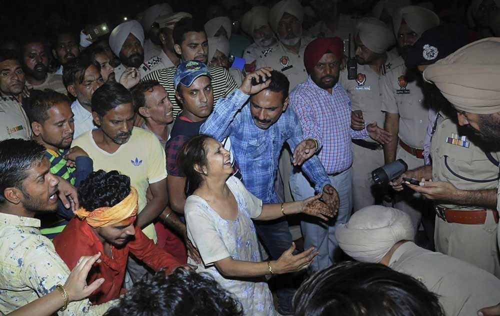 Relatives mourn at the site of a train accident at Joda Phatak in Amritsar on Friday. Officials said at least 60 bodies have been found and many more injured have been admitted to a government hospital after the accident near the site of Dussehra festivities. PTI Photo