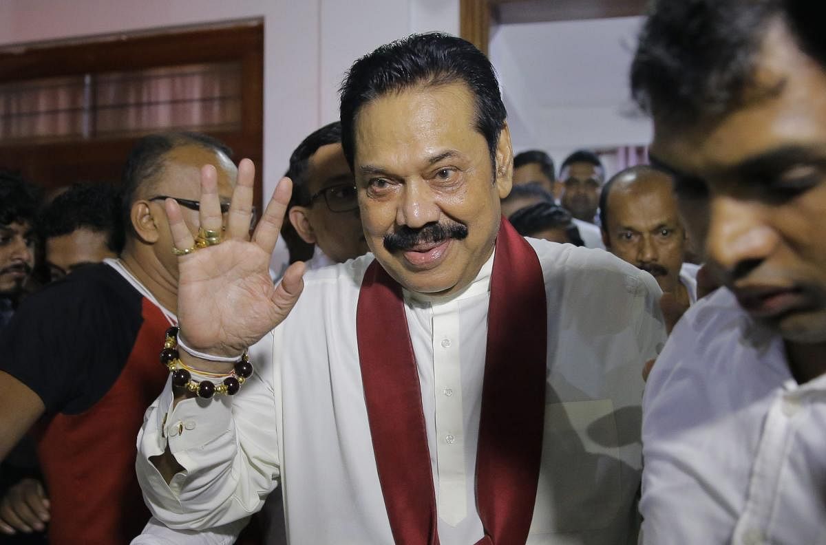 Newly appointed Sri Lankan Prime Minister Mahinda Rajapaksa, center, leaves a Buddhist temple after meeting his supporters in Colombo, Sri Lanka, Friday, Oct. 26, 2018. Sri Lankan President Maithripala Sirisena has sacked the country's prime minister and replaced him with a former strongman, state television said Friday. AP/PTI