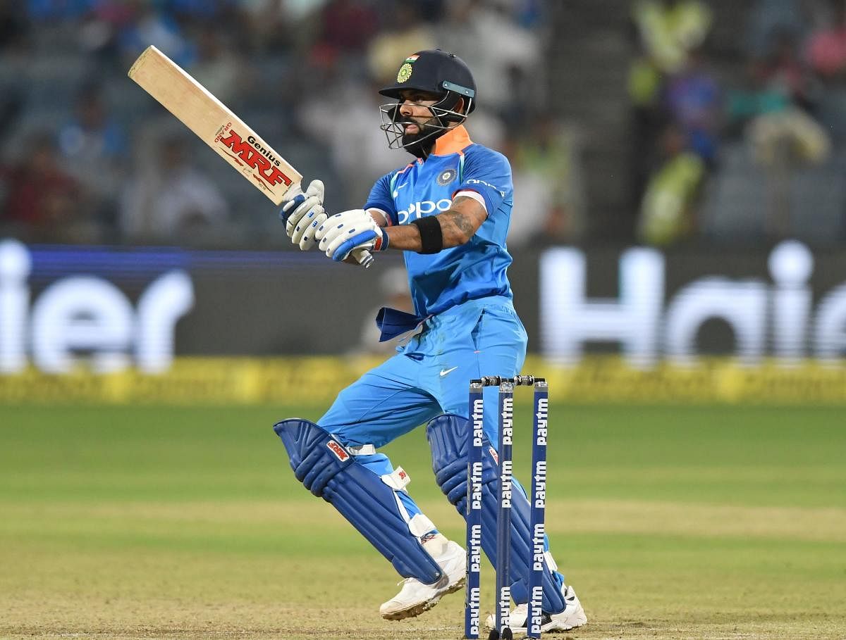 Virat Kohli plays a shot during the third one day international (ODI) cricket match between India and West Indies at the Maharashtra Cricket Association Stadium in Pune on October 27, 2018. (Photo by PUNIT PARANJPE / AFP) 