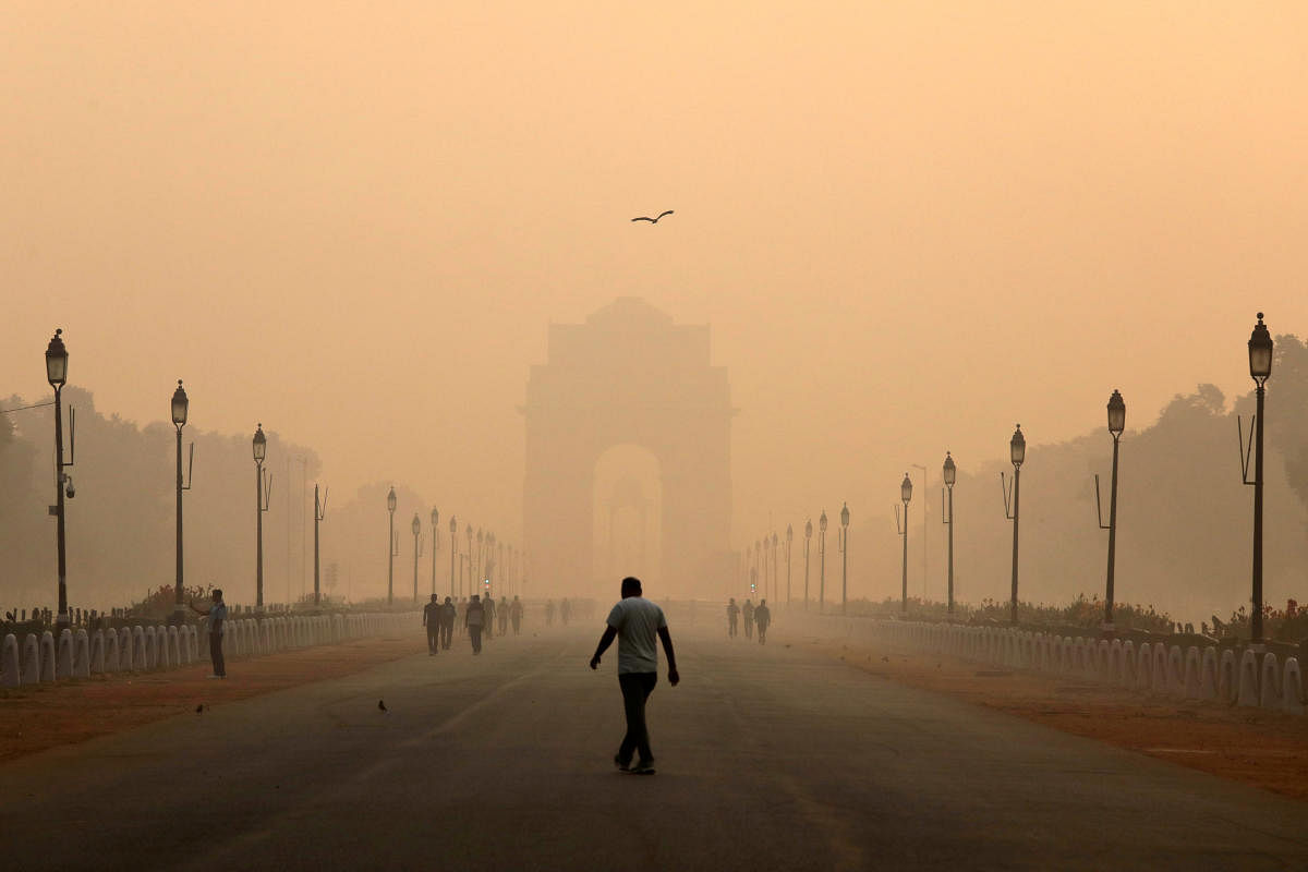 A man walks in front of the India Gate shrouded in smog in New Delhi, India, October 29, 2018. REUTERS