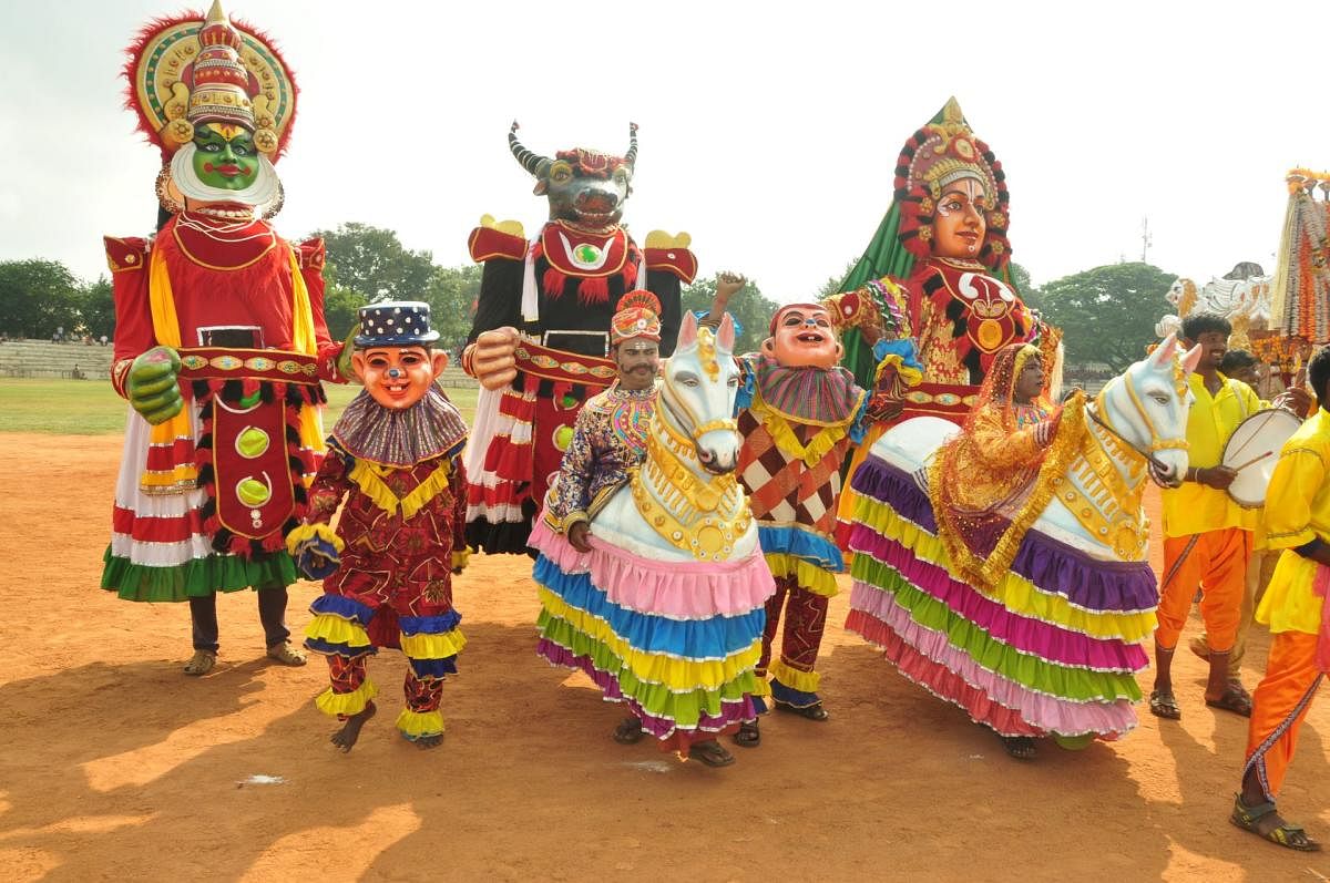 A folk troupe poses for a picture during the Kannada Rajyotsava celebrations in Mandya on Thursday. DH photo