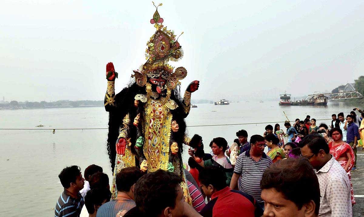 Devotees immerse an idol of Goddess Kali at River Ganga in Kolkata on Wednesday.Nove 07,2018 PTI Photo