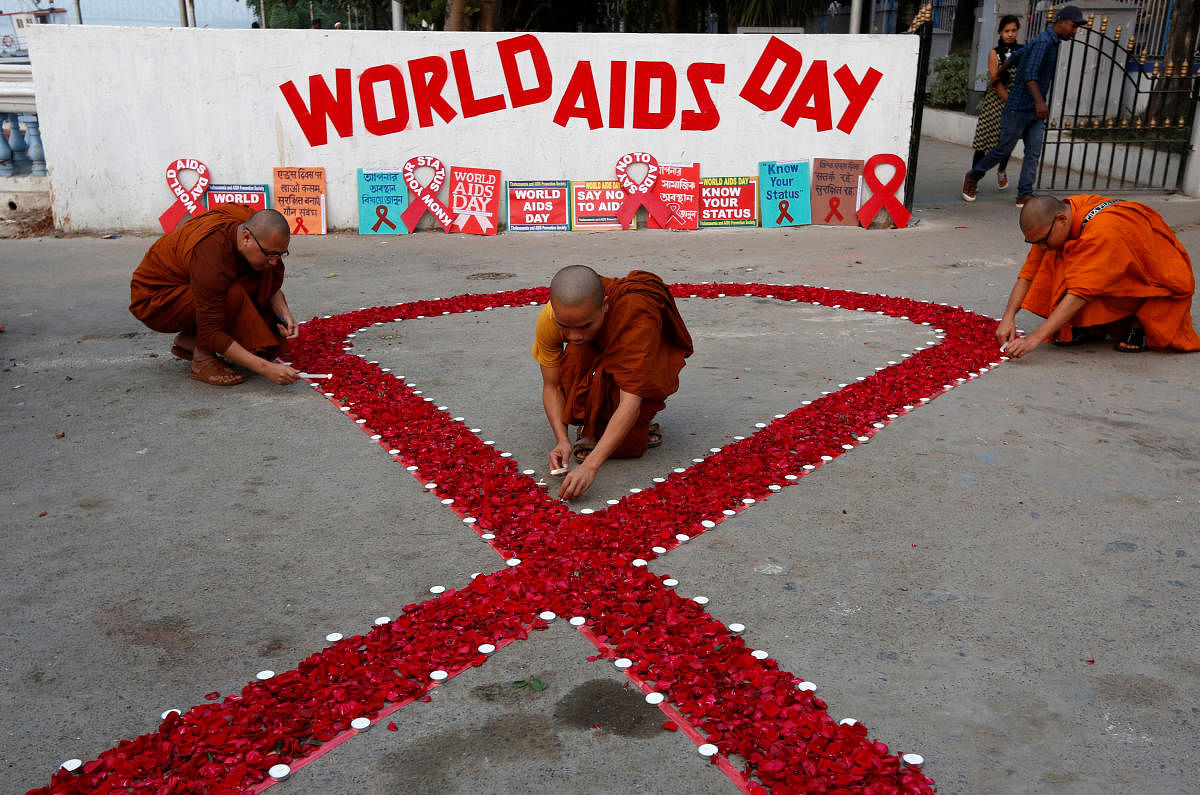 Buddhist monks light candles during an HIV/AIDS awareness campaign on the occasion of World AIDS Day in Kolkata. (Reuters Photo)