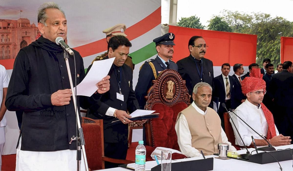 Rajasthan Chief Minister Ashok Gehlot being administered the oath of office as Governor Kalyan Singh and newly-elected Rajasthan Deputy Chief Minister Sachin Pilot look on, at Albert Hall, in Jaipur, Monday, Dec. 17, 2018. (PTI Photo) 